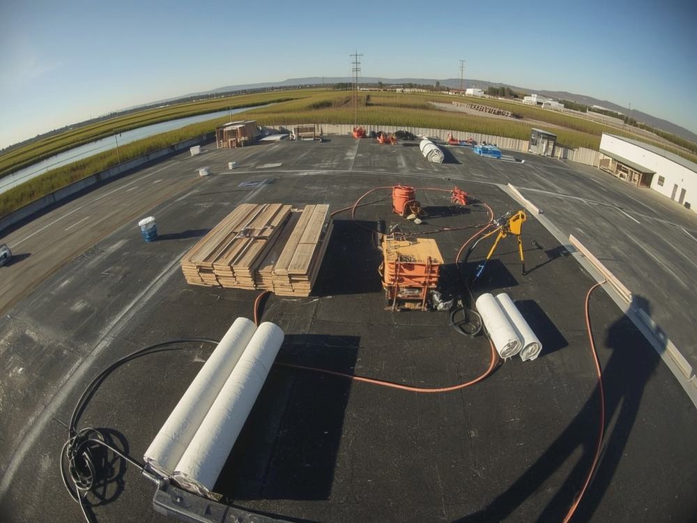 Roofing membrane, insulation boards and equipment staged on a commercial roof in Suisun City, California